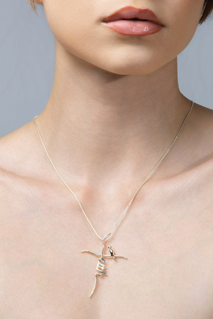 Faith Necklace  (crucifix with a little bird) - Guided by Faith Collection